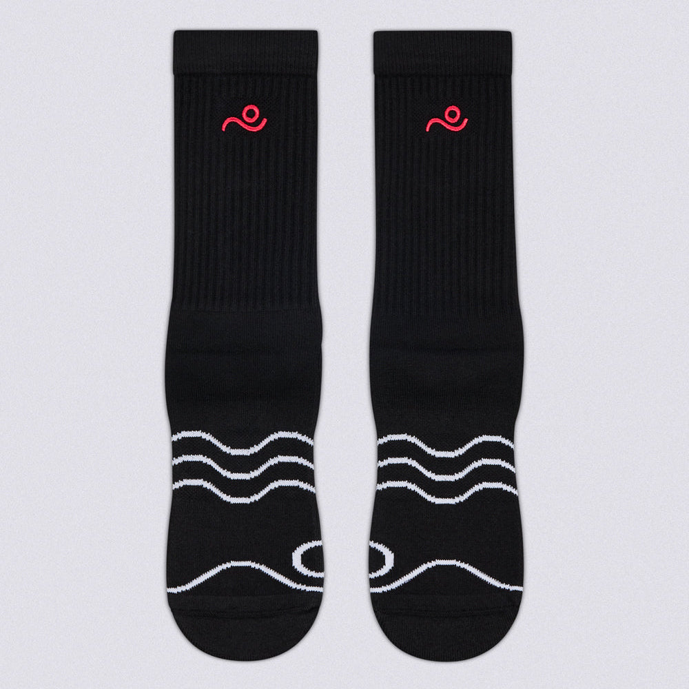 A pair of black crew socks with white wavy line patterns on the toes and a small red embroidered logo near the cuff, displayed flat against a light gray background.