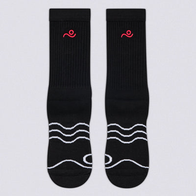 A pair of black crew socks with white wavy line patterns on the toes and a small red embroidered logo near the cuff, displayed flat against a light gray background.